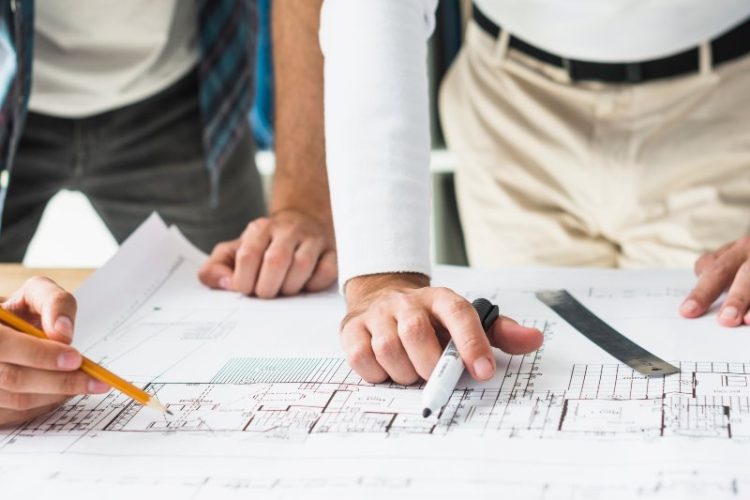 close-up-two-male-architect-s-hand-blueprint (1)